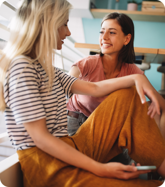 Two women sit and bond